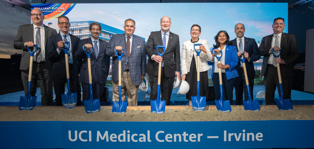 Dignitaries take the traditional first shovel dig. From left to right: James Pratt, associate vice chancellor and campus architect; Dr. Michael Stamos, dean, UCI School of Medicine; Dr. Steve A.N. Goldstein, vice chancellor, health affairs; UC Regent John Pérez, Chancellor Howard Gillman; Dr. Carrie Byington, executive vice president, UC Health; Irvine mayor Farrah N. Khan; Chad Lefteris, CEO, UCI Health; Brian Hervey, vice chancellor, university advancement.